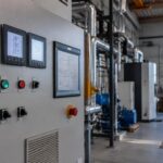 Décarboner une PME belge : panneau de contrôle énergétique avec compteurs et jauges dans un atelier belge